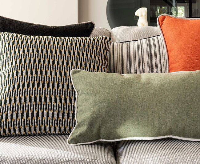Assortment of throw pillows showcasing various patterns and sizes, featured in a 2022 most loved products article