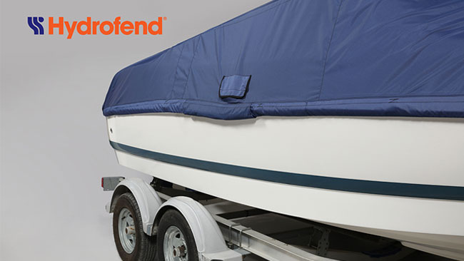 Made in USA Hydrofend cover fabric in blue being used to protect a boat while in storage.