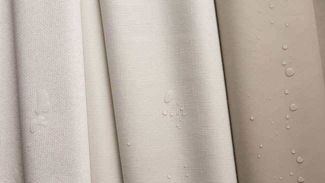 Three new Sunbrella Horizon marine vinyl upholstery fabric rolls featuring water droplets.