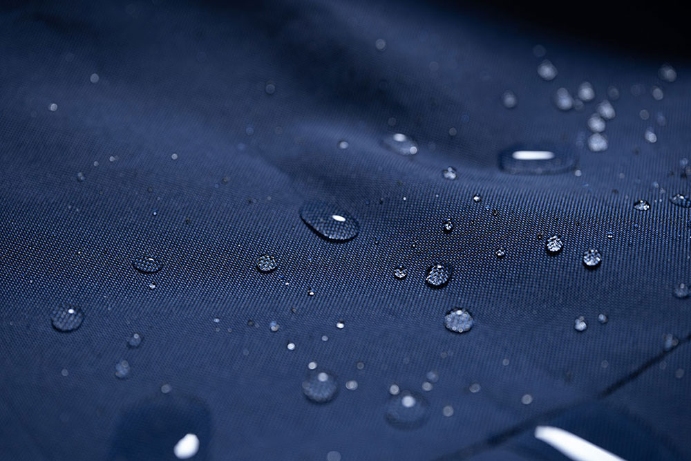 Close-up of water droplets on a water-repellent Hydrofend marine cover fabric in blue