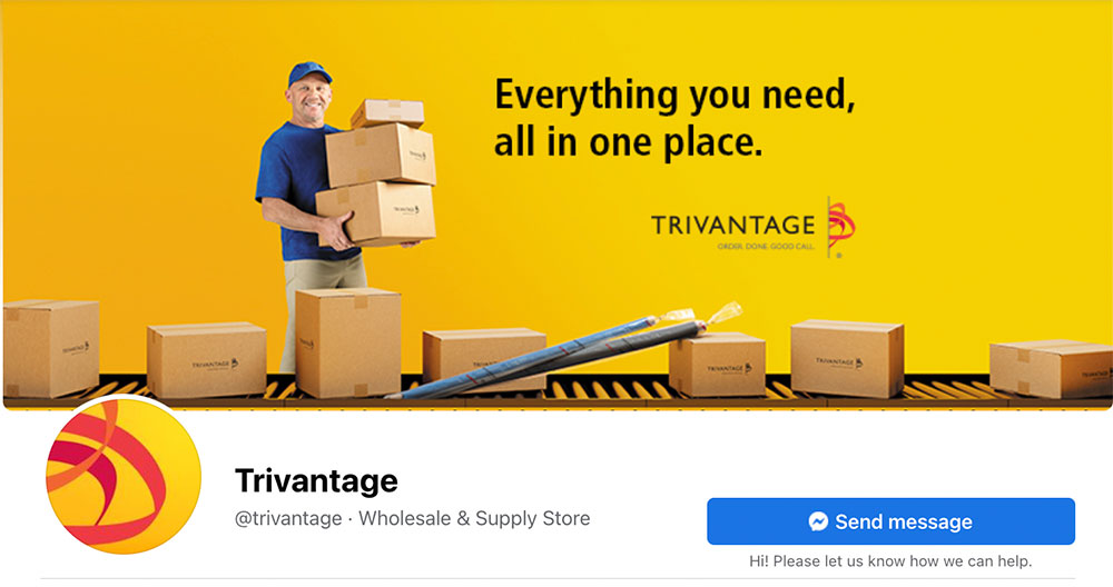 Smiling man holding brown boxes on Trivantage Wholesale & Supply Store webpage
