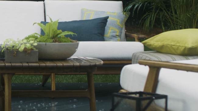 Still of outdoor furniture in the rain upholstered with Sunbrella outdoor upholstery fabric.