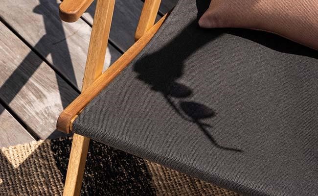 Image of a sling fabric chair made with Sunbrella Sling Fabric featuring a sunglasses shadow