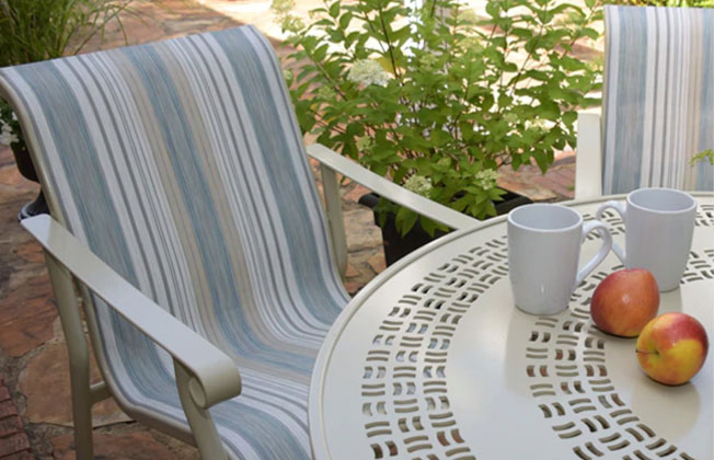 striped fabric on outdoor dining chair next to a table
