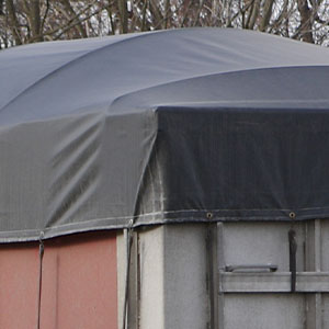 Darkgrey trivantage-gvc18 fabric strapped down over a structure