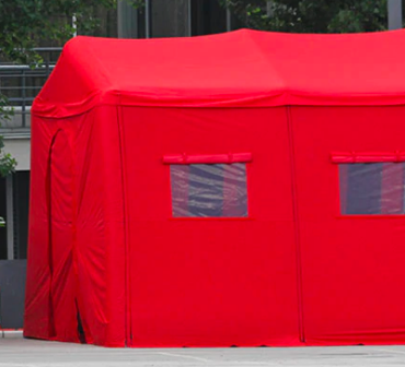 A bright red tent with two windows