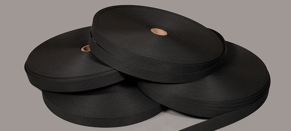 four rolls of black nylon webbing for upholstery