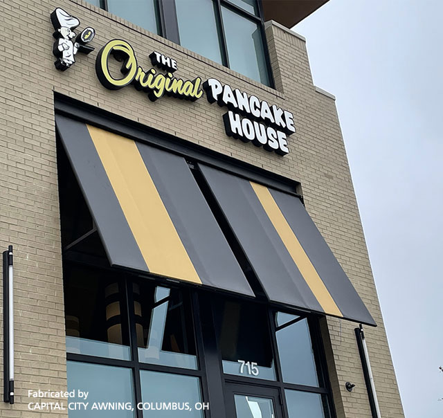 Exterior of a Pancake House with black and yellow striped window awning