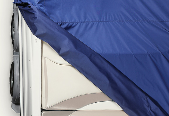 A blue marine cover fabric on portion of a boat