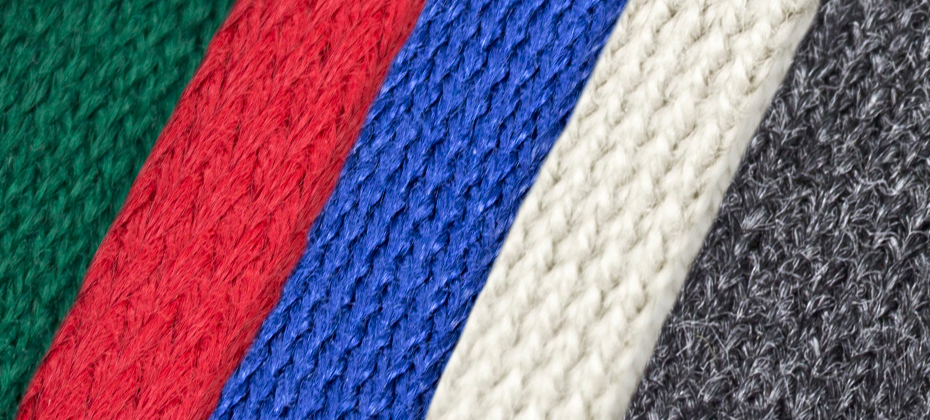 close up texture of awning braid in green, red, blue, white, grey