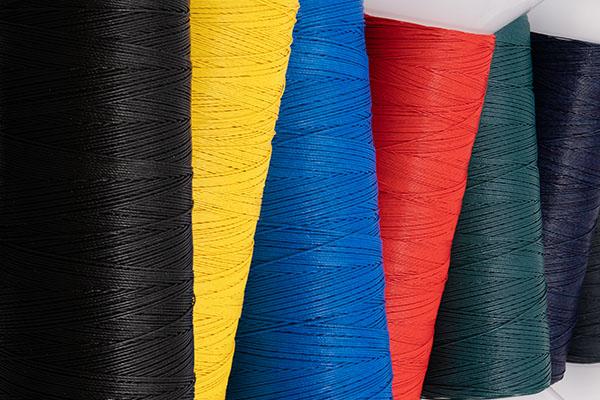 Several spools of various solid colored threads