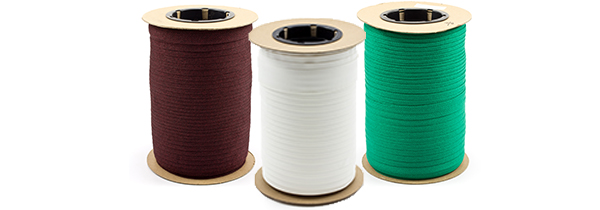 Rolls of trim and cord for marine binding and awning braid in shades of brown, white and green