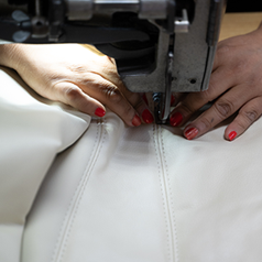 hands guiding a stitch with sewing machine