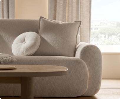 right side of a couch covered in ivory colored fabric