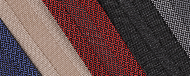 Close up textured view of different colors of binding for professional upholstery and industrial sewing