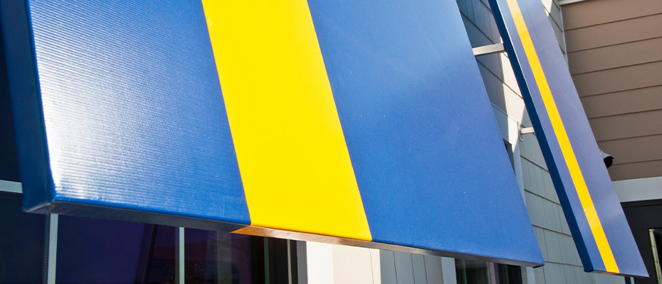Cooley-Brite blue and yellow awning fabric hung over windows